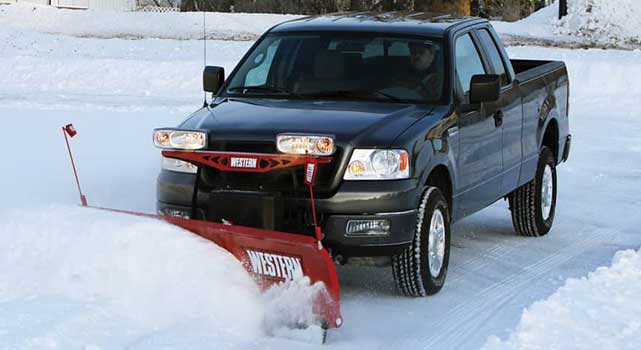 Western snow plow on a Ford F-Series pickup.